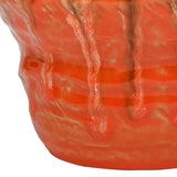 Close-up of Libra Interiors Reactive Glaze Ceramic Planter showing glossy orange drip glaze, textured rippled body and amber-brown pooling detail.