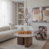Libra Interiors Wire Frame Burnished Brass Pendant Light with three-tier caged silhouette above a marble coffee table in a neutral living room.