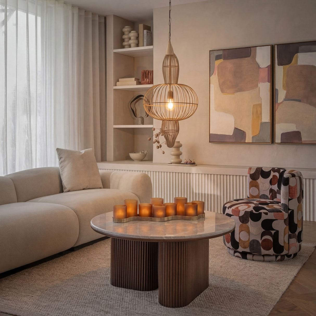 Libra Interiors Mira Orb burnished brass wire pendant light with tiered cage silhouette above a marble coffee table in a neutral living room.