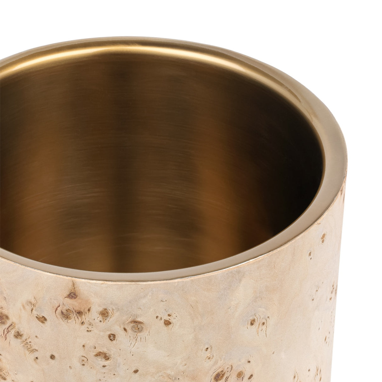 Close-up of the Libra Interiors Burl Veneer Brass-Lined Wine Rack showing the burnished brass stainless steel liner inside the natural burl wood sleeve.