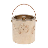 Libra Interiors burlwood veneer ice bucket with burnished brass lid, knob and tan leather arched handle, shown on a plain white background.