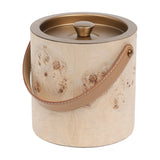 Libra Interiors burlwood veneer ice bucket with burnished brass lid, shaped knob and tan leather arched handle on a plain background.