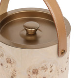 Close-up of Libra Interiors burlwood veneer ice bucket showing burnished brass lid with shaped knob and tan leather handle on brass fixings.