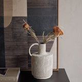 Libra Interiors Textured Cross-Hatch Handle Vase in cream holding dried banksia and grasses, styled on a dark console beside an abstract framed artwork.