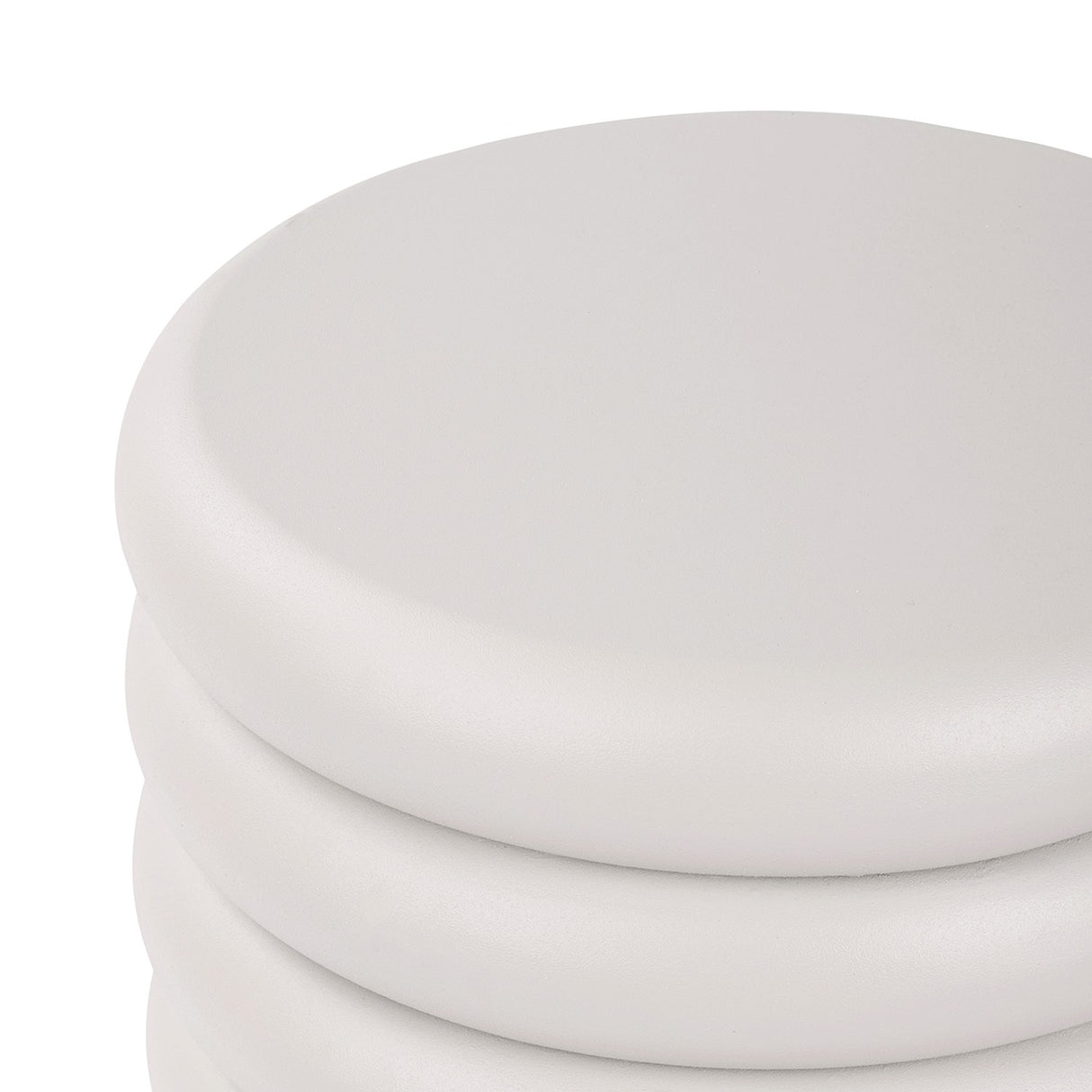 Close-up of the domed top and upper ribbed bands of the Libra Interiors Ribbed Iron Sculptural Side Table in cream with a matte textured finish.