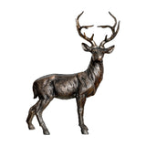 Libra Interiors Textured Bronze Standing Stag Sculpture in resin with tall antlers and warm metallic bronze finish, shown on a plain white background.