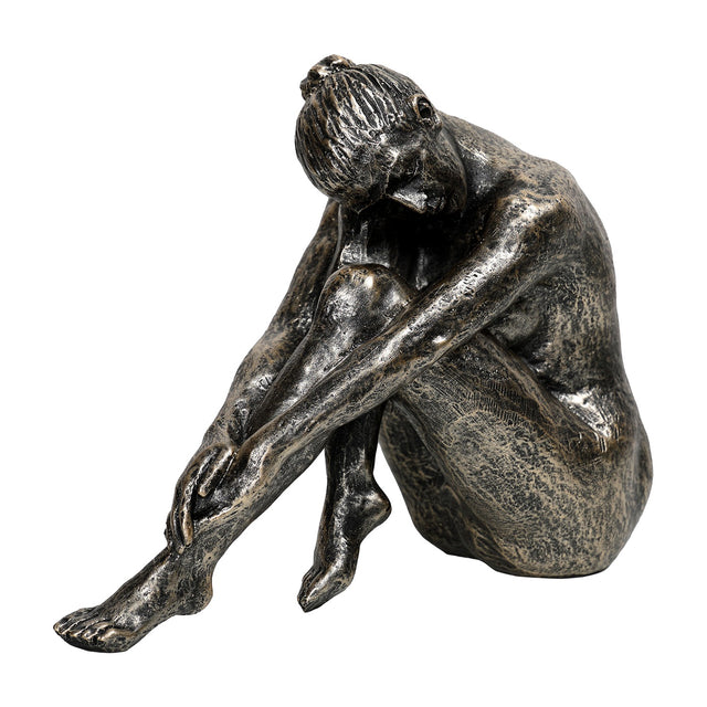 Libra Interiors Textured Resin Seated Female Sculpture in antique gold, posed with head resting on bent knees and one leg extended, on a white background.