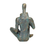 Libra Interiors Verdigris Seated Reading Man resin sculpture shown from the back, faceted form in antique gold and blue patina on a white background.