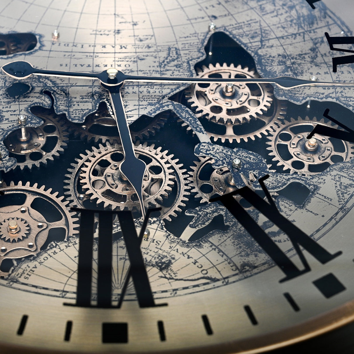 Close-up of the Libra Interiors Clock Top Round Antique Gold Side Table glass surface showing moving brass cogs, Roman numerals and world map print.