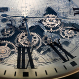 Close-up of the Libra Interiors Clock Top Round Antique Gold Side Table glass surface showing moving brass cogs, Roman numerals and world map print.