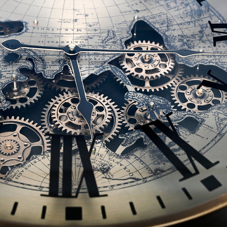 Close-up of the Libra Interiors Clock Top Round Antique Gold Side Table glass surface showing moving brass cogs, Roman numerals and world map print.
