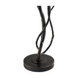 Close-up of the Libra Interiors Branch Iron Twig Table Lamp base, showing hand-forged black iron stems with bronze highlights rising from a round weighted base.