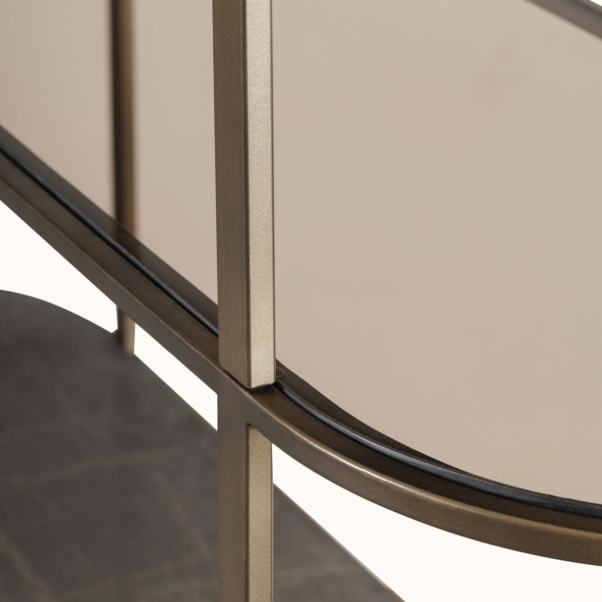 Close-up of the Libra Interiors Asymmetric Pebble Gilded Wall Mirror showing the corrugated iron frame in gilded oak tone against reflective glass.