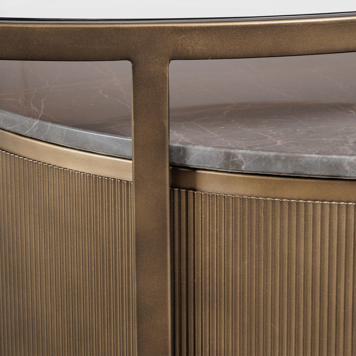 Close-up of Libra Interiors Marble & Glass Round Nesting Coffee Table in gold, showing tinted glass top, grey marble tier and fluted metal drum base.