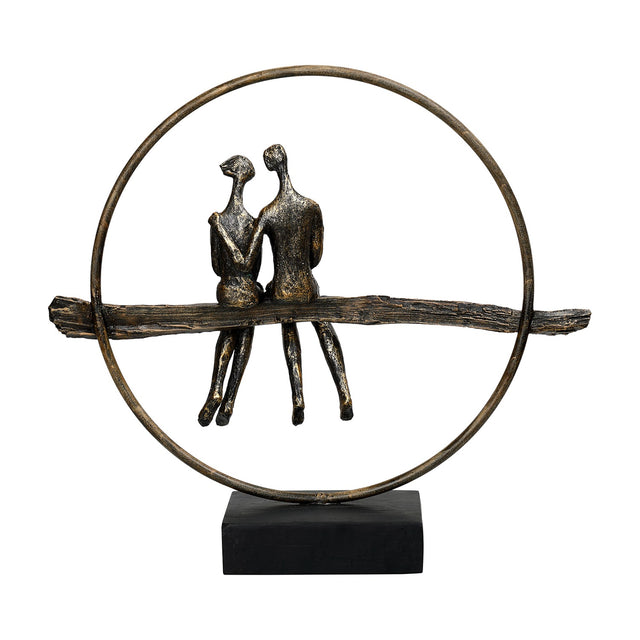 Libra Interiors Antique Gold Circle Seated Couple Sculpture with two resin figures on a textured branch inside a metallic ring on a black base.
