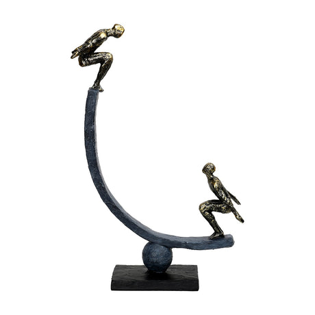 Libra Interiors Rough Cast Two Figure Balance Sculpture in bronze, with two crouched figures on a curved arc balanced over a sphere on a rectangular plinth.