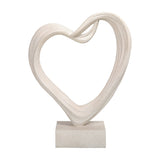 Libra Interiors Grainy Resin Abstract Heart Sculpture in white with a twisted open form and square base, shown on a plain background.