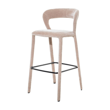 Libra Interiors Velvet Wrapped Curved Back Bar Stool in taupe, with sculptural curved back, fabric-covered tapered legs and black powder coated metal footrest.
