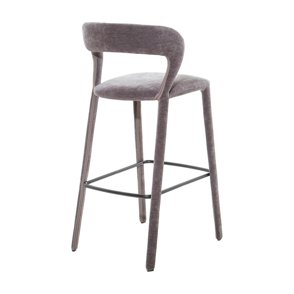 Libra Interiors Velvet Curved-Back Bar Stool in grey with a low curved backrest, upholstered legs and black powder coated steel footrest, on a white background.
