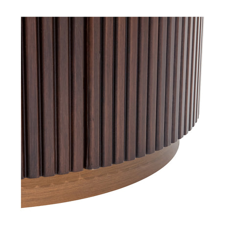 Close-up of Libra Interiors Fluted Walnut Bedside Table showing the curved vertical fluting in deep walnut above an antique brass base.