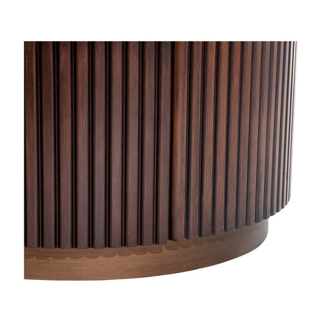 Close-up of Libra Interiors Fluted Walnut Chest of Drawers with curved rubberwood base, deep vertical fluting and matching plinth in walnut finish.