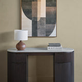 Libra Interiors Marble Top Fluted Walnut Pedestal Desk in brown styled with a wooden lamp and Matisse books beneath a geometric artwork.