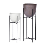 Libra Interiors Hammered White Aluminium Planters on Stands, showing the white bowl beside a larger brown bowl on slim black metal frames.