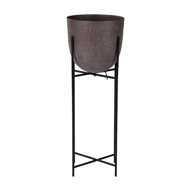 Libra Interiors Hammered Aluminium Raised Planter in brown, a curved matt stonewash pot set on a tall slim black iron four-leg stand, on a white background.