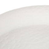 Close-up of the Libra Interiors Stonewash Hammered Round Bowl in white, showing its matt aluminium surface with subtle hammered texture and undulating rim.