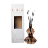 Libra Interiors Palo Santo sculptural glass reed diffuser in warm brown with a double-gourd vessel, black reeds, and branded box on a white background.