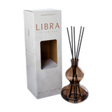 Libra Interiors Palo Santo reed diffuser in a brown double-gourd glass vessel with black reeds, beside its white Libra branded box.