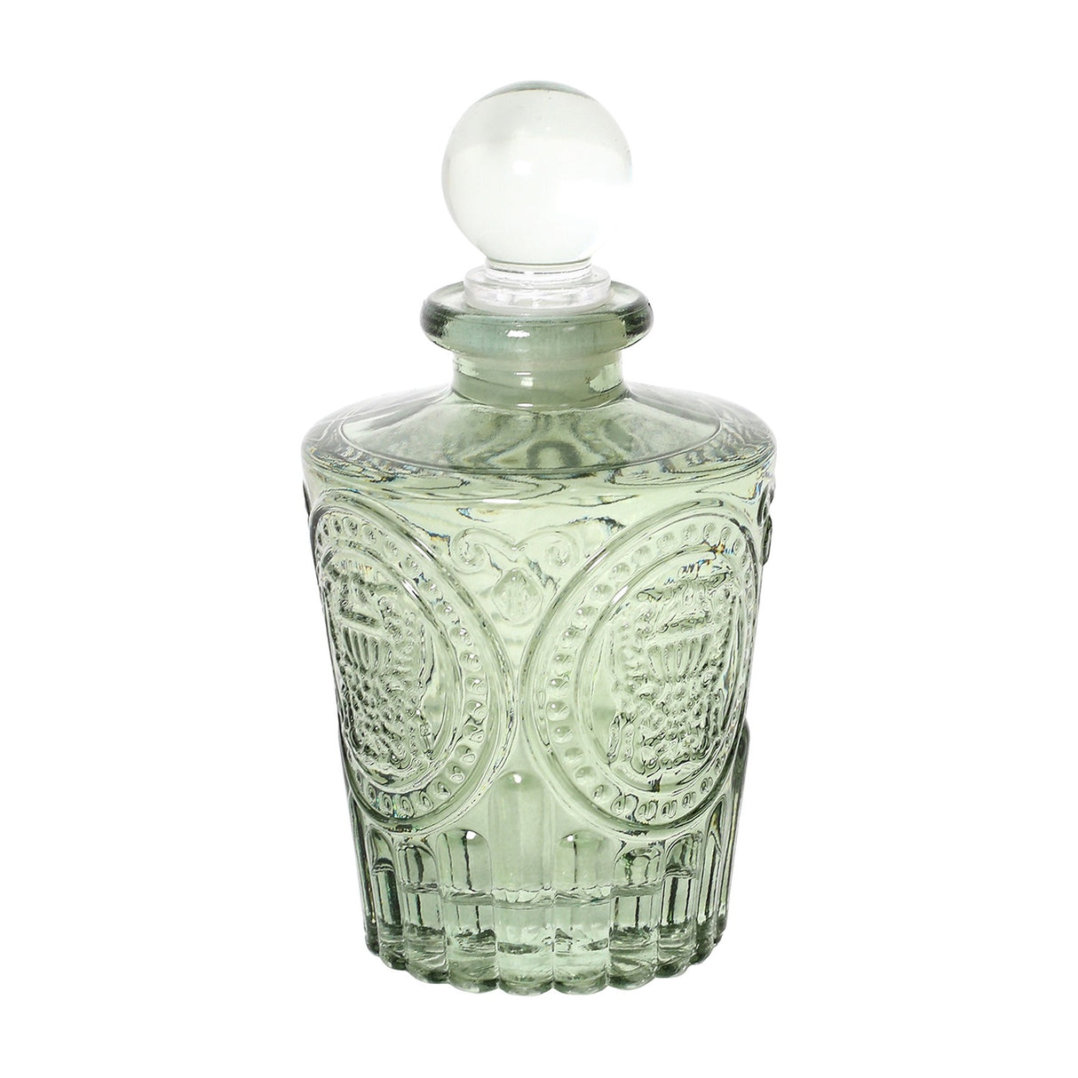 Libra Interiors Embossed Glass Reed Diffuser in green with vintage apothecary shape, medallion patterning and spherical glass stopper, on a white background.