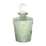 Libra Interiors Embossed Glass Reed Diffuser in green with vintage apothecary shape, medallion patterning and spherical glass stopper, on a white background.