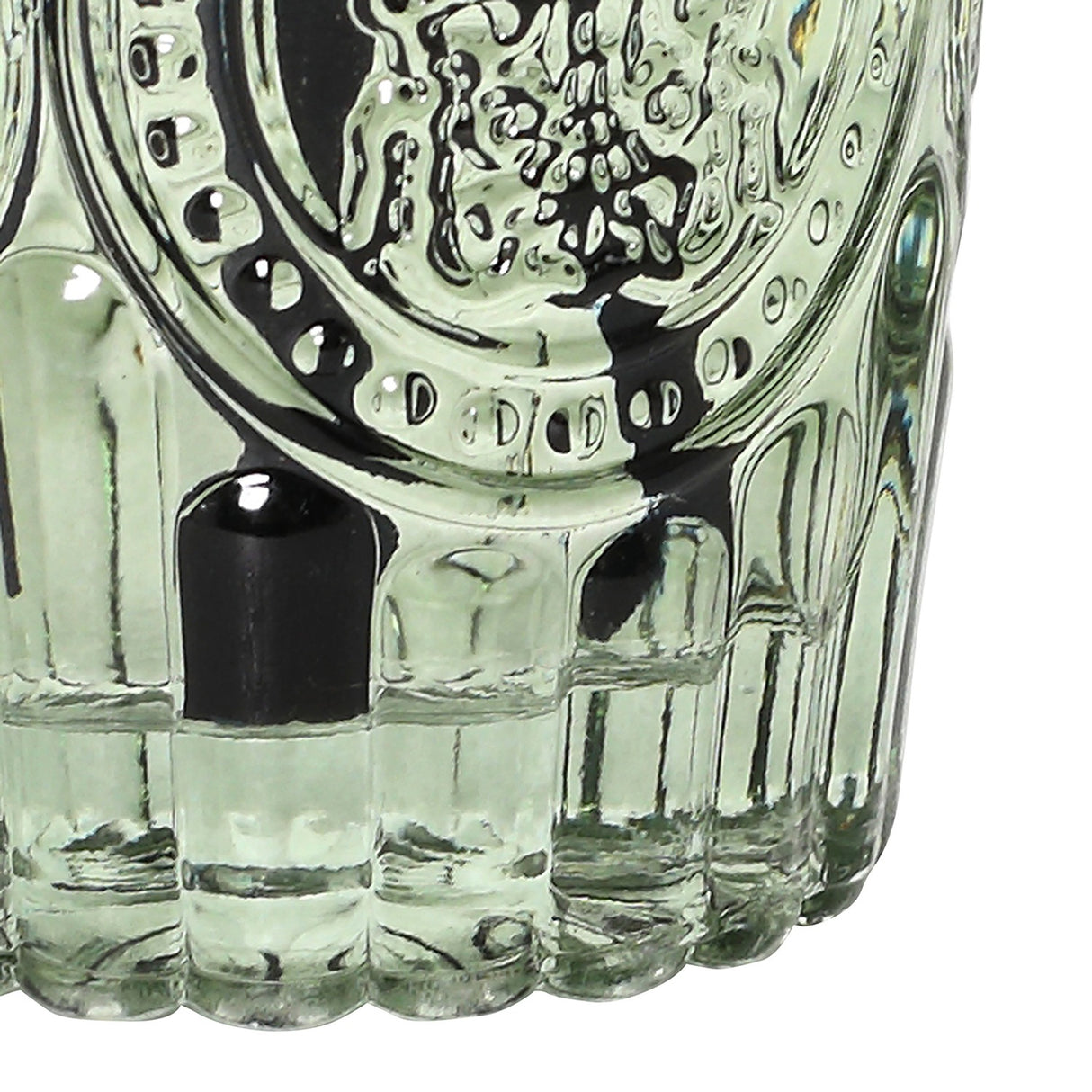 Close-up of the Libra Interiors Embossed Glass Reed Diffuser in green, showing the fluted base and embossed detailing with black reeds.