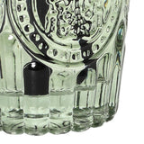 Close-up of the Libra Interiors Embossed Glass Reed Diffuser in green, showing the fluted base and embossed detailing with black reeds.