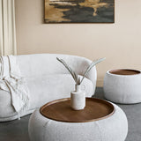 Libra Interiors Chenille Round Storage Ottoman in cream with inset walnut tray, styled with a vase in a boucle sofa living room setting.