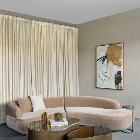 Libra Interiors Curved Velvet Modular Sofa in mocha brown with cushions, styled beside a marble coffee table and abstract artwork in a neutral living room.