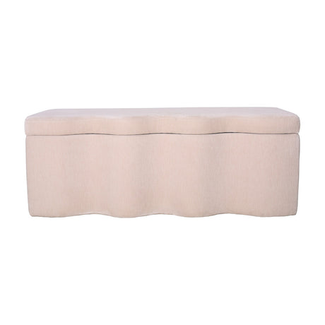 Libra Interiors Velvet Lift-Top Storage Ottoman in cream with a softly curved sculpted base and padded hinged top, shown on a plain white background.