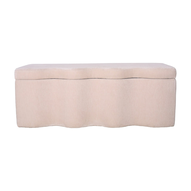 Libra Interiors Velvet Lift-Top Storage Ottoman in cream with a softly curved sculpted base and padded hinged top, shown on a plain white background.