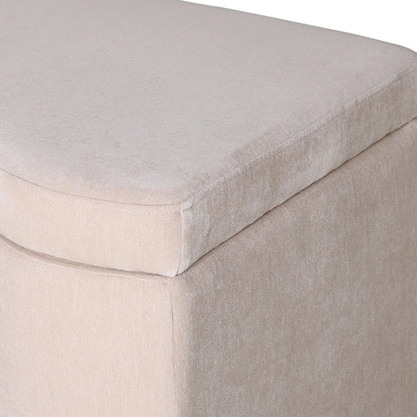 Close-up of Libra Interiors Velvet Lift-Top Storage Ottoman in cream, showing the short-pile velvet upholstery and piped seam along the lift-top lid edge.