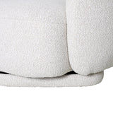 Close-up of the Libra Interiors Bouclé Swivel Accent Armchair in cream, showing the textured looped weave across the curved seat and base.