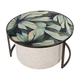 Libra Interiors Printed Glass Nesting Coffee Table in black with round green leaf-print top, bronze-tone iron frame and oatmeal fabric pouffe tucked beneath.