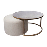 Libra Interiors Round Map-Print Glass Nesting Coffee Table with brass-toned iron frame and neutral cobble-weave fabric pouffe tucked beneath.