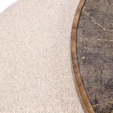 Close-up of Libra Interiors Round Map-Print Glass Nesting Coffee Table showing the printed world map glass top, brass-toned frame, and cobble-weave pouffe.