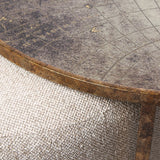Close-up of Libra Interiors Round Map-Print Glass Nesting Coffee Table with printed world map top, brass-toned iron frame and woven fabric pouffe beneath.