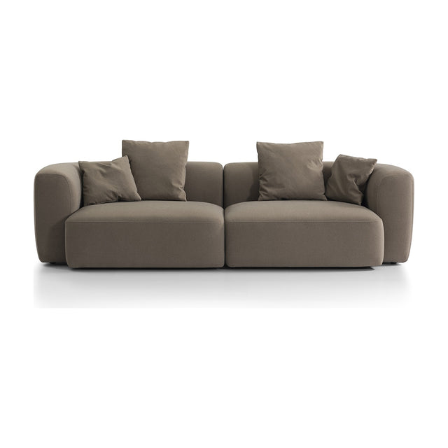 Libra Interiors Velvet Curved 2-Seater Modular Sofa in truffle beige, with rounded arms, deep seats and loose scatter cushions, on a plain white background.