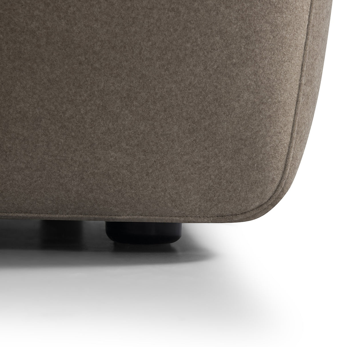Close-up of the Libra Interiors Velvet Curved 2-Seater Modular Sofa in truffle, showing the short-pile velvet upholstery and rounded black plinth foot.