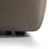 Close-up of the Libra Interiors Velvet Curved 2-Seater Modular Sofa in truffle, showing the short-pile velvet upholstery and rounded black plinth foot.