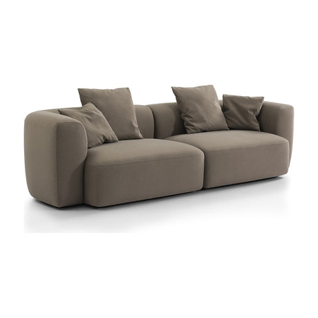 Libra Interiors Velvet Curved 2-Seater Modular Sofa in truffle beige with rounded sculptural frame, deep seats and loose scatter cushions on a white background.
