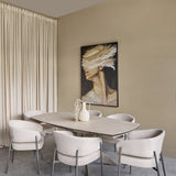 Libra Interiors extendable ceramic dining table in warm stone with brushed grey metal base, styled with boucle chairs in a neutral dining room.
